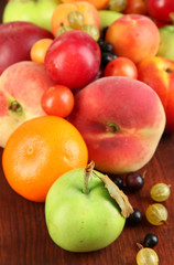 Fototapeta na wymiar Assortment of juicy fruits, on wooden background