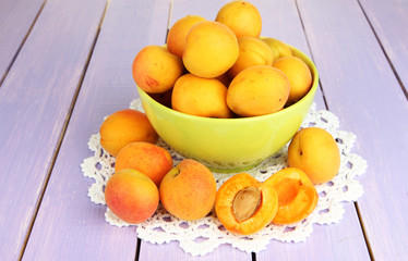 Fresh natural apricot in bowl on wooden table