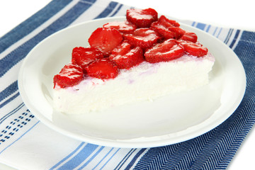 Cheesecake with fresh berries on white plate closeup