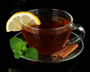 Cup of tea with lemon isolated on black