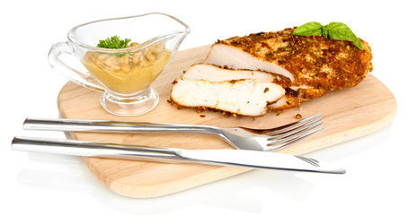 Roasted chicken fillets on wooden board, isolated on white