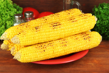 Delicious golden grilled corn on table on wooden background