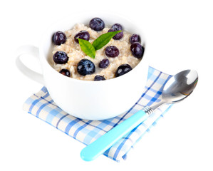Oatmeal in cup with berries isolated on white
