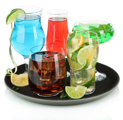 Many glasses of cocktails on tray, isolated on white