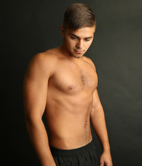 Portrait of muscle man on grey background