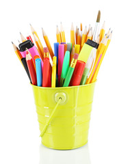Colorful pencils and other art supplies in pail isolated