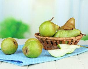 Pears in  wicker basket, on light background