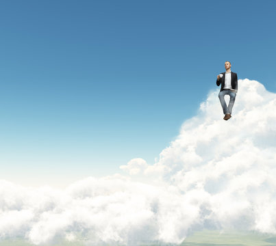 Man With Cup Of Coffee Sitting On A Cloud