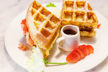 Waffles with syrup and strawberries