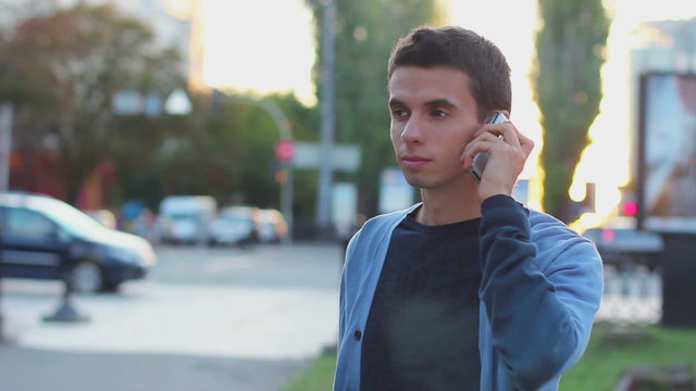 Man calls dials number no answer serious young male outdoors