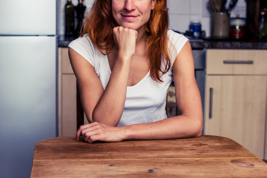 Happy woman relaxing in her kitchen