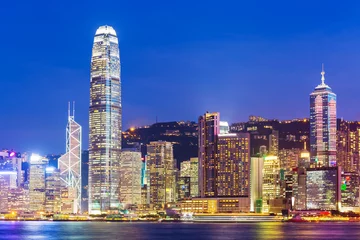 Poster Hong Kong city skyline at night with Victoria Harbor and skyscra © leungchopan