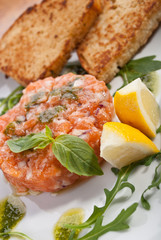 Salmon tartar with lemon and toasts