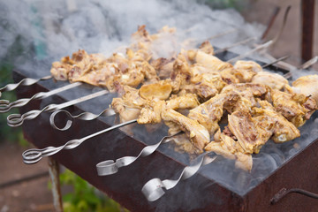 skewers of fried chicken on the grill