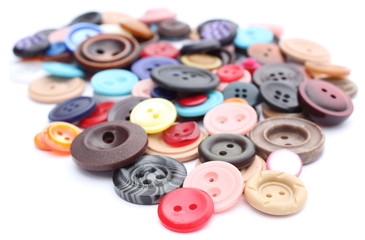 Collection of various sewing buttons on white background