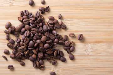 brown coffee beans on wooden background