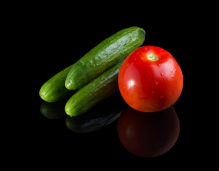 Washed vegetables on black background.