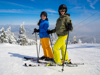 Teenage girl and boy skiing