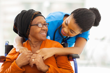 african senior patient with female nurse - 55712895