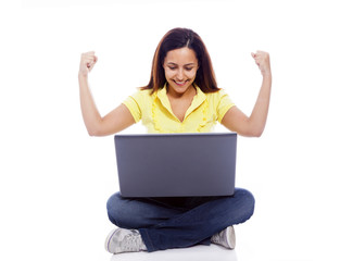 Beautiful woman with a laptop and raised arms, isolated over whi