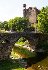 Day view of ancient church and medieval bridge