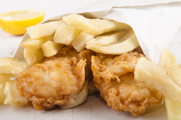 french fries and fish in a white bag