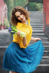 Happy young woman with bouquet of flowers