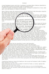 Hand holding magnifying glass reading document - 55723483