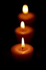 Fototapeta na wymiar Candles on a black background, decoration