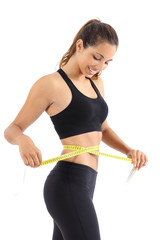 Fototapeta na wymiar Sportswoman measuring her waist with a measure tape