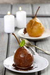 Pear with chocolate sauce. French dessert. Selective focus