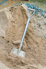 shovel and sand in construction place