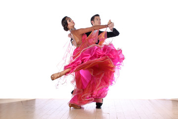 Latino dancers in ballroom against white background