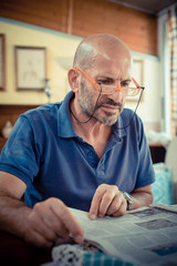 miggle age man reading newspaper