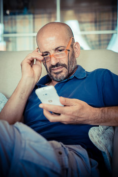 miggle age man using phone