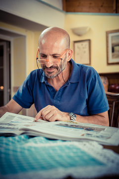 Miggle Age Man Reading Newspaper