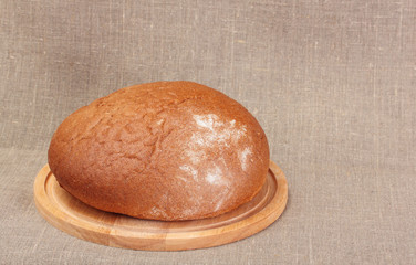loaf of rye bread on sacking