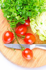 tomatoe, parsley, cabbage on wood desk
