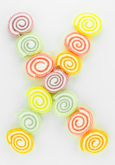Letter X written with slices of dried sweet candies