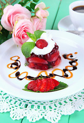 Tasty jelly dessert with fresh berries, on pink roses