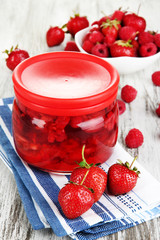 Home made berry jam on wooden table