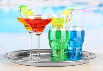 Different  colorful cocktails on bright background