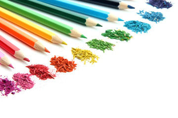 Colour pencils with sharpening shavings isolated on white