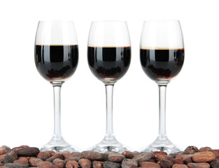 Glass of liquor and cocoa beans, isolated on white
