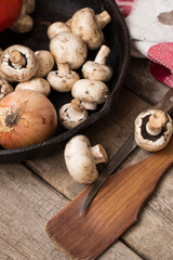 Mushrooms and fresh vegetables on the rusty pan