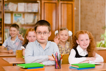 Portrait of pupils looking at camera in classroom