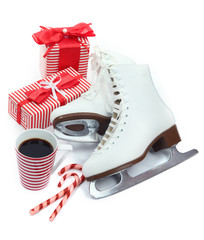 Figure skates with cup of coffee isolated on white