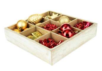 Wooden box filled with christmas decorations, isolated on white