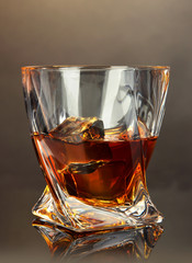 Glass of whiskey, on dark background