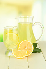 Delicious lemonade on table on light background